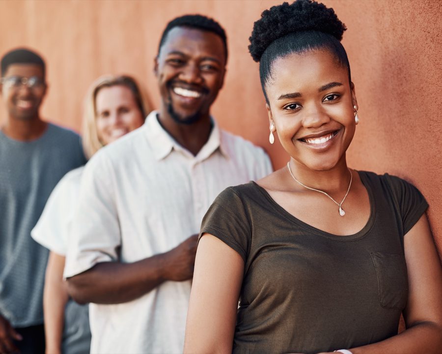 A group of Kuumba Code learners standing together, smiling