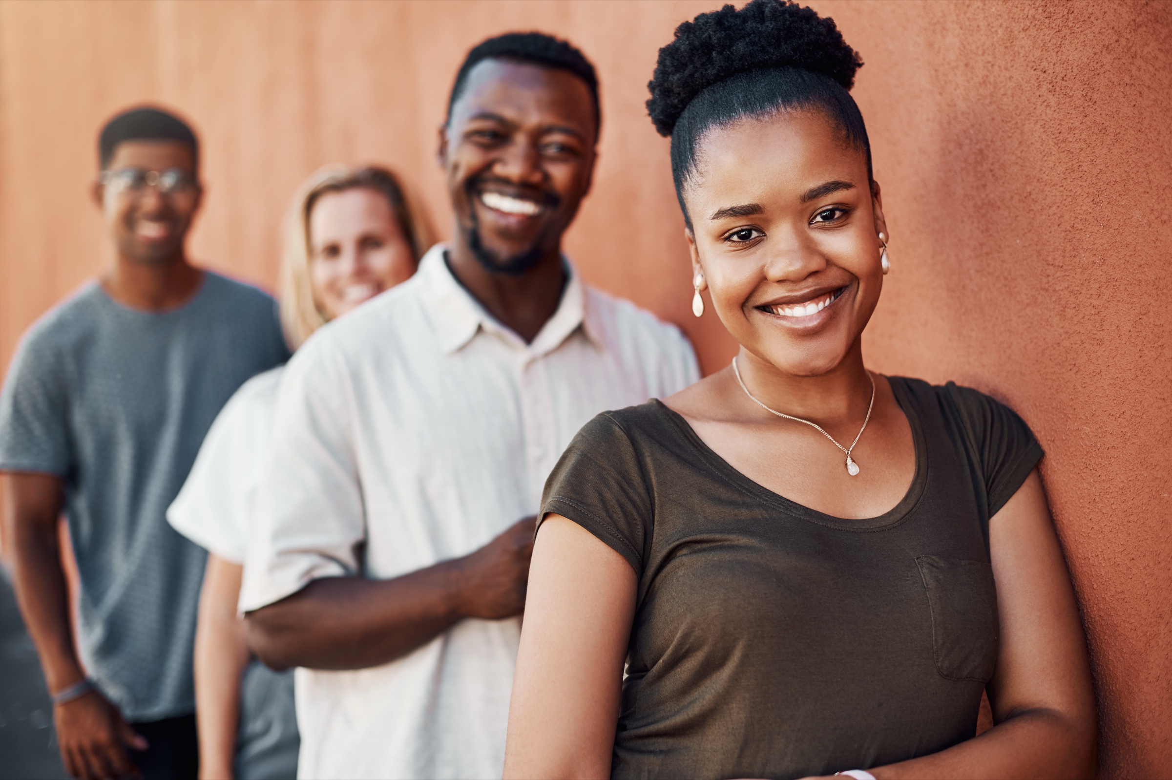 A welcoming group of young adults smiling — get in touch with Kuumba Code
