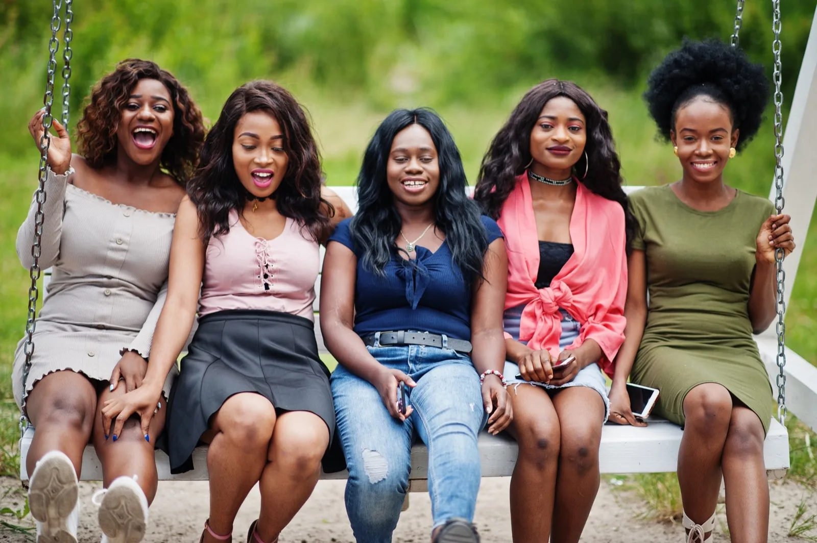 Young women sitting together outside, learning