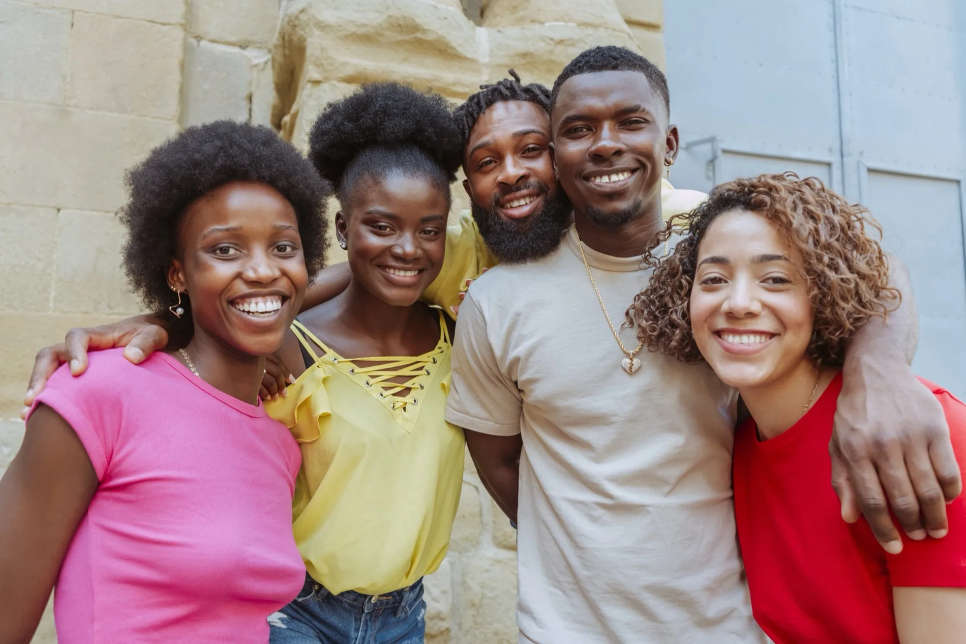 A group of young adults together, smiling