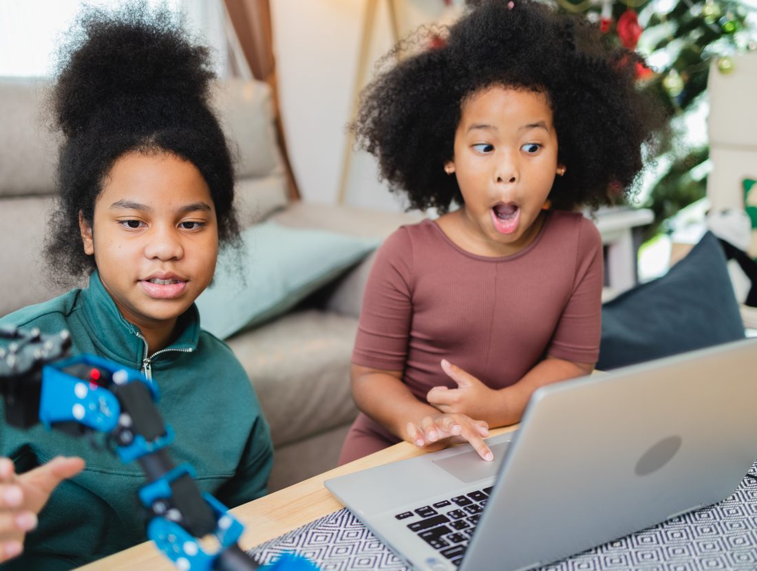 A child reacting with delight to a change she just made in her game