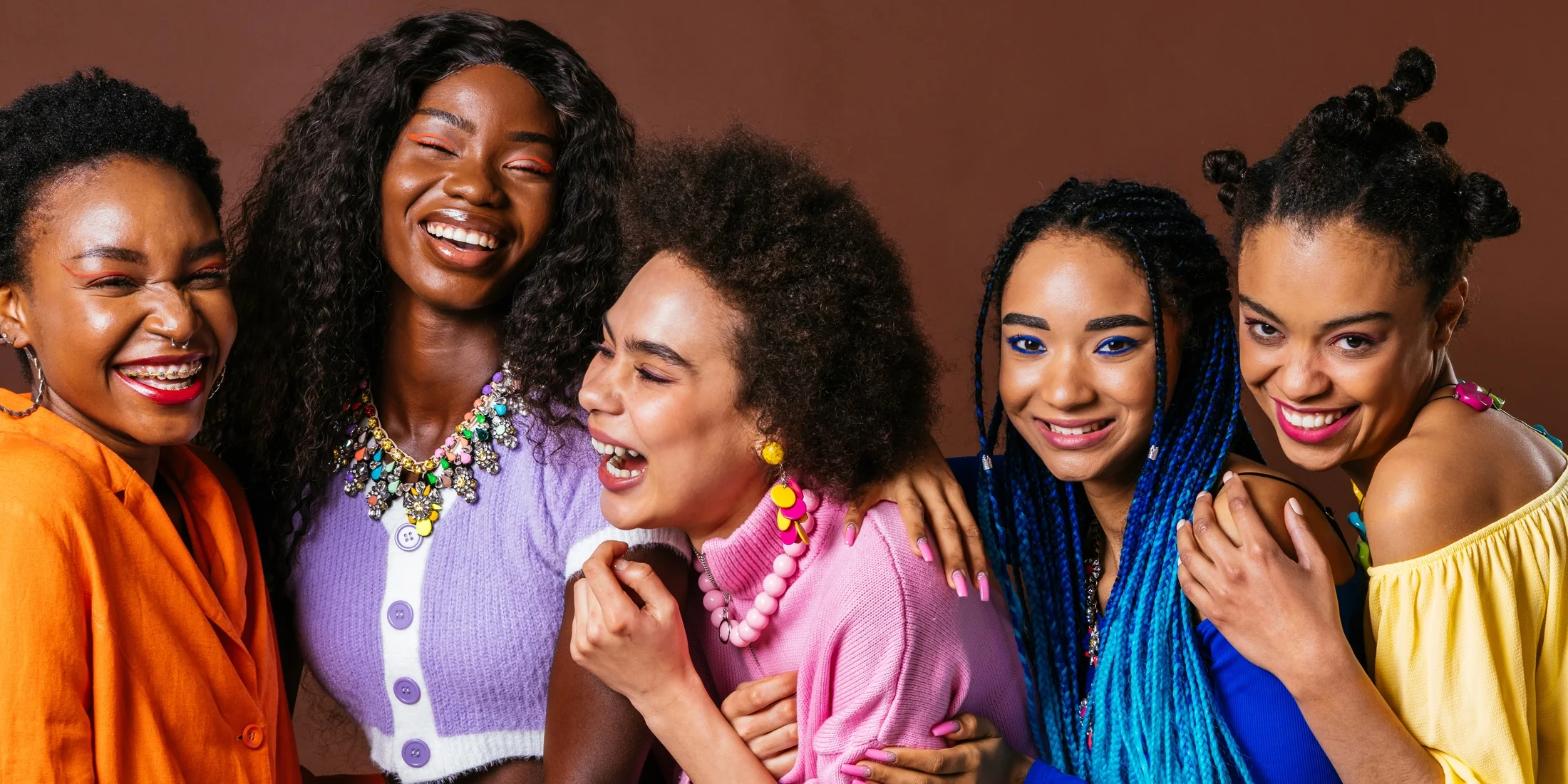 Young women together, laughing — watch our story